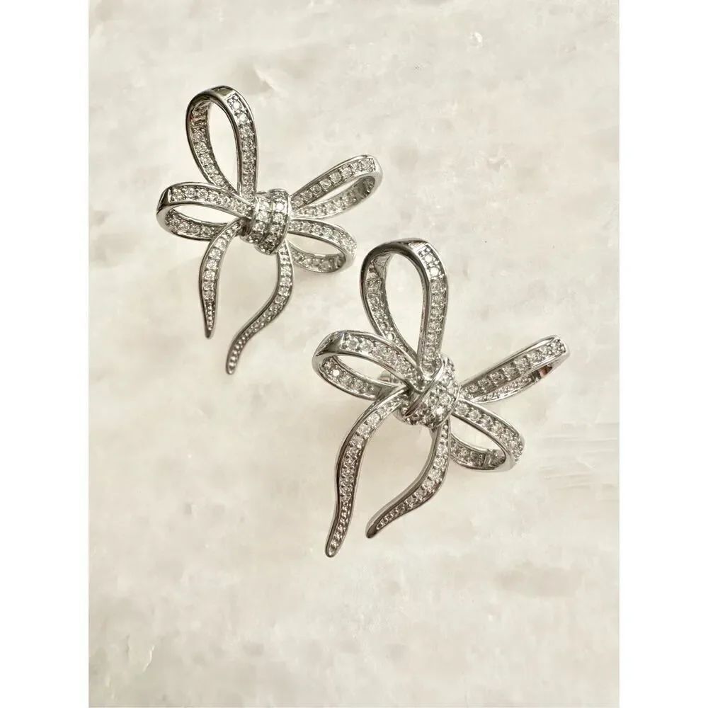 Silver color bow dangle earrings